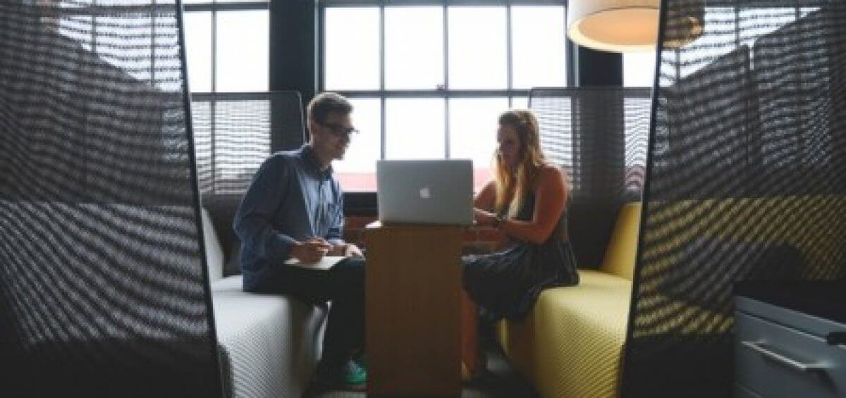 Man and woman working together in their open work space