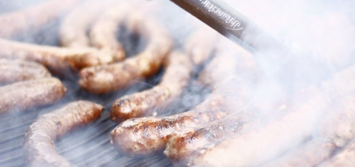 Sausages being cooked on BBQ grill