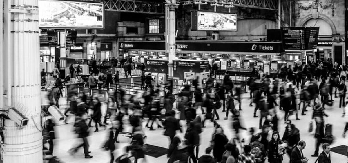 Snapshot of bodies walking through a Victoria station