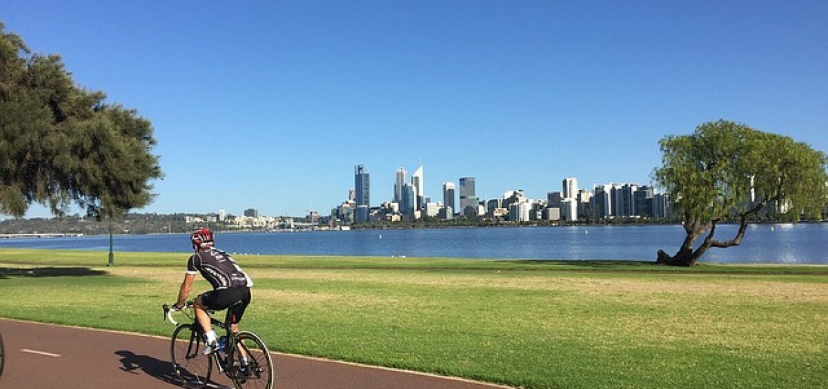 Man cycling in Perth, one of the top 10 most liveable cities