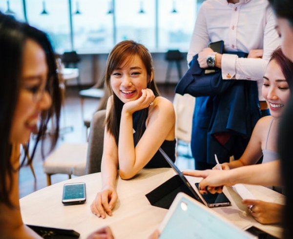 Group of young Asian adults enjoying a workplace conversation for 5 Australia visa changes to expect in 2019