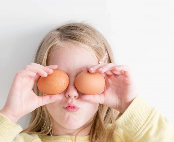 Young girl with two eggs over her eyes for Easter Perth celebrations