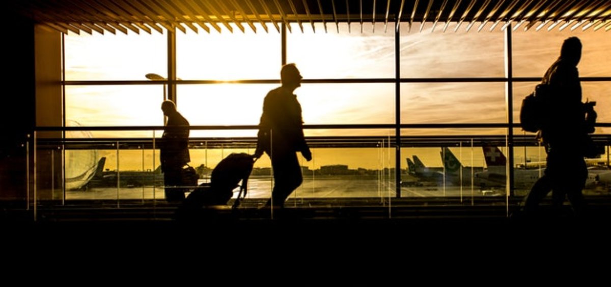 Silhouettes of individual who has traveled to Australia on motorised tract in airport. Australian immigration changes.