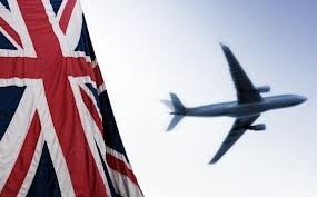 Airplane flying in the sky with part of a flag visible in the foreground
