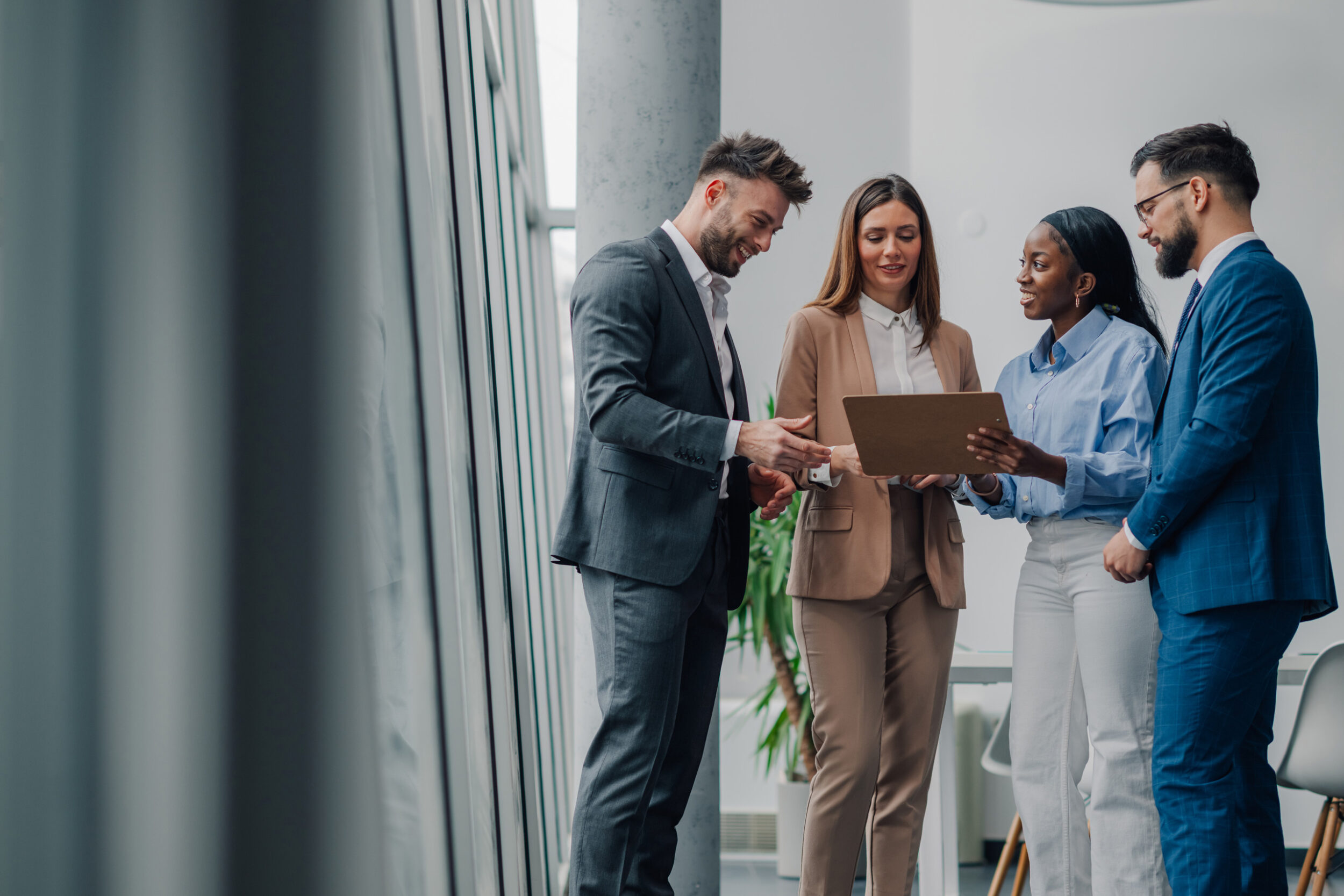 Diverse professionals collaborating in modern office reviewing migration documents