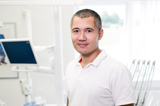 Portrait of smiling business man inside of medical facility