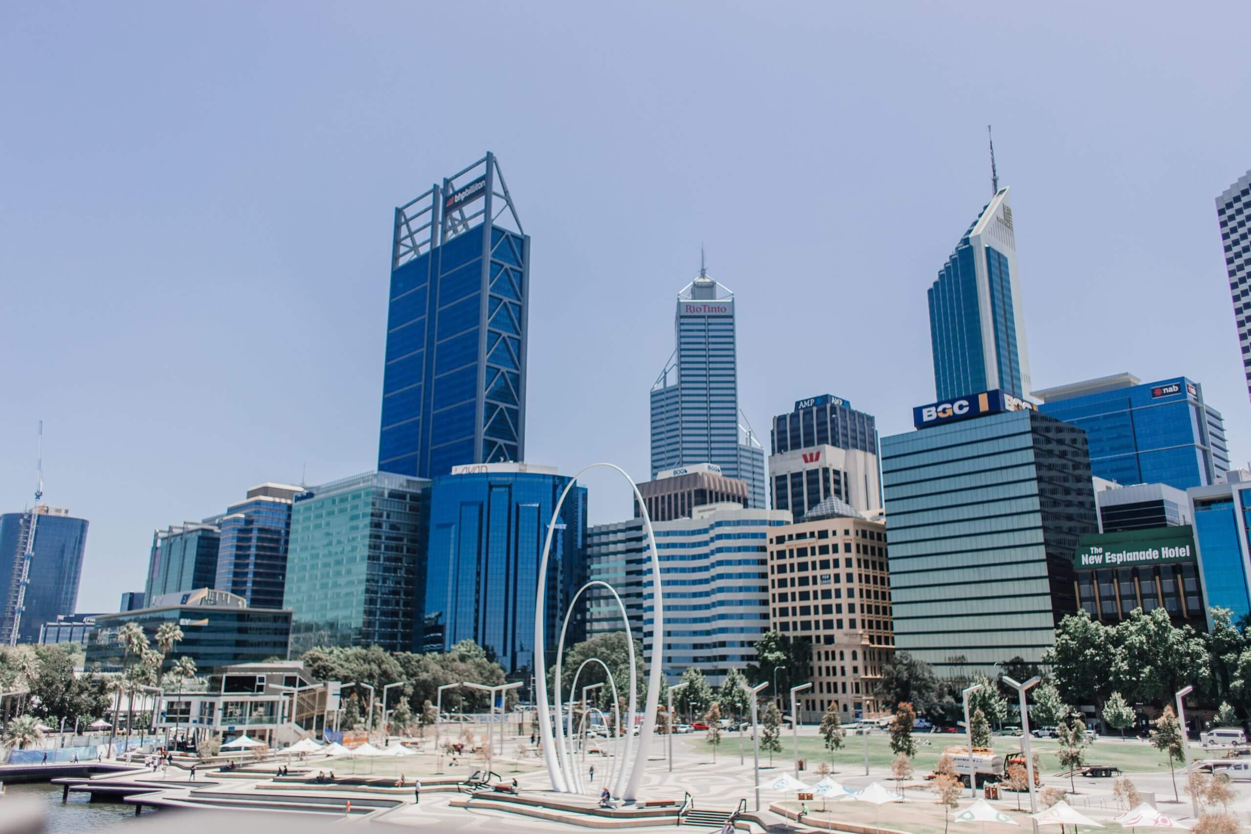 City skyline with tall buildings viewed from a public open area during daytime