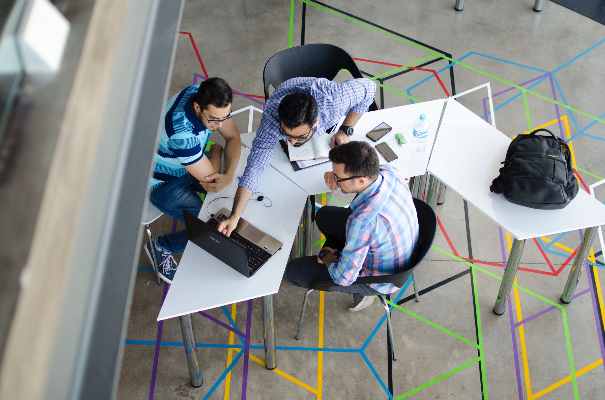 Group of workers discussing the Skilled Occupation List in 2020 in open workspace