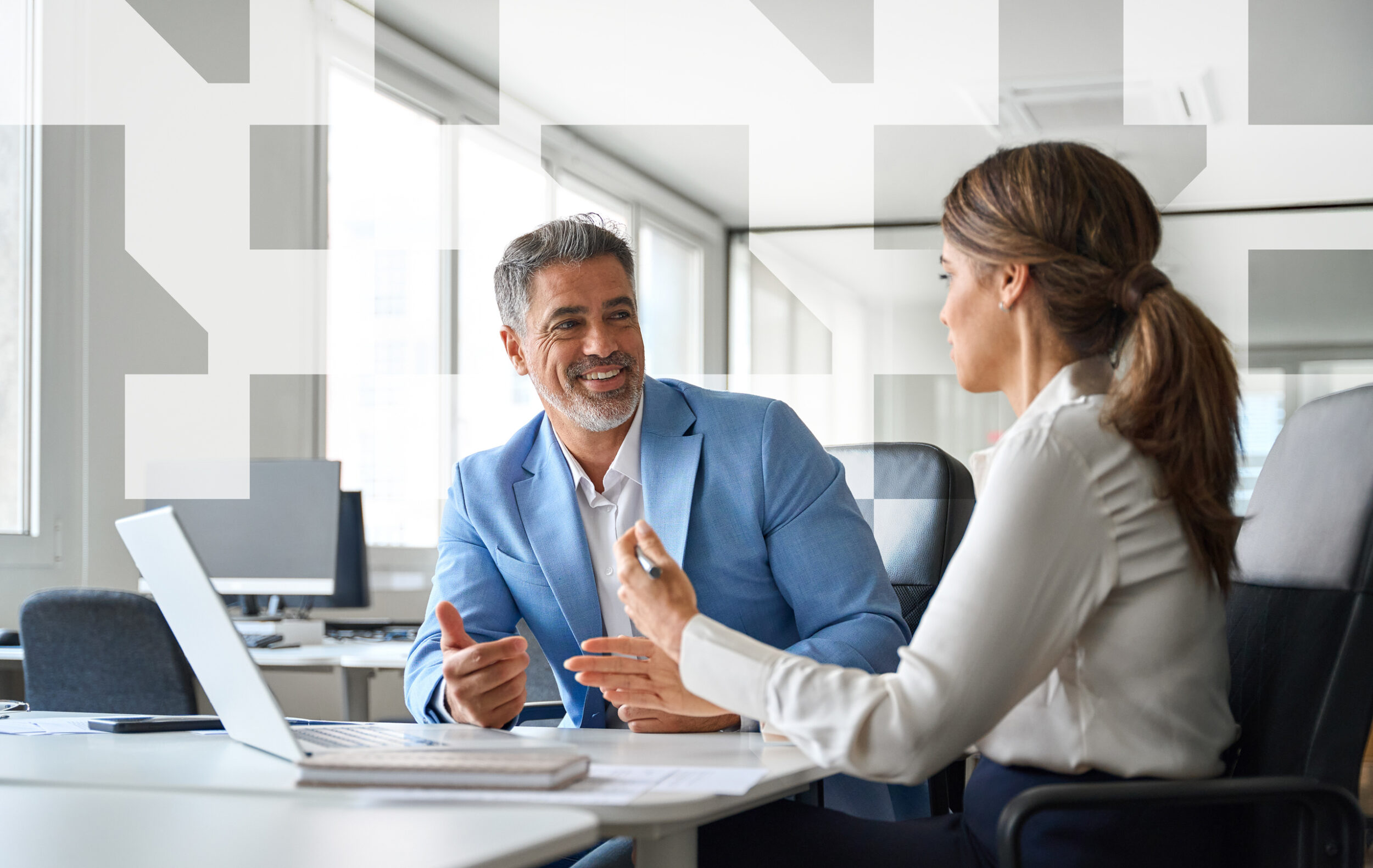 Business professional discussing visa sponsorship options with a client during a one-on-one office meeting